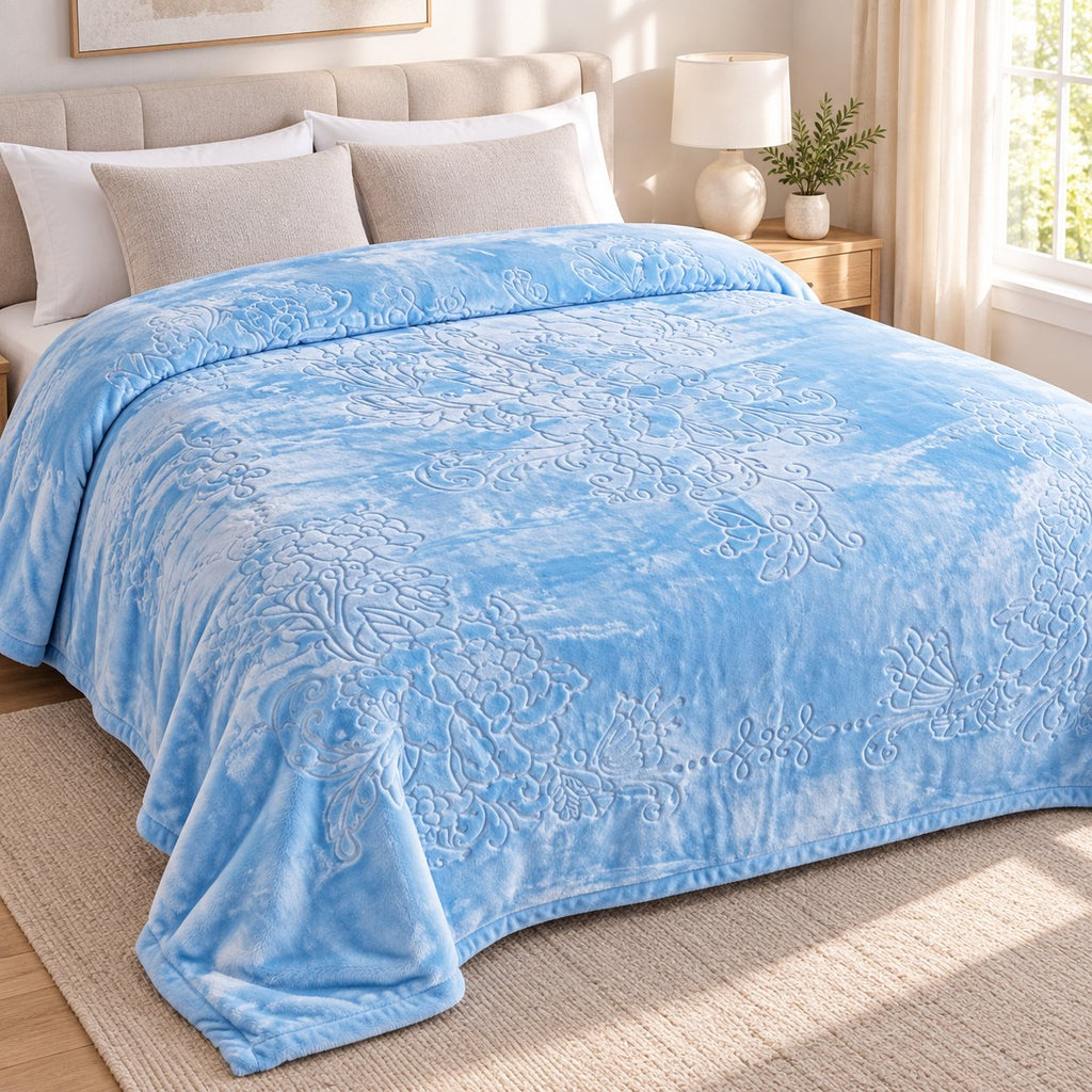 Blue embossed floral king blanket styled on bed