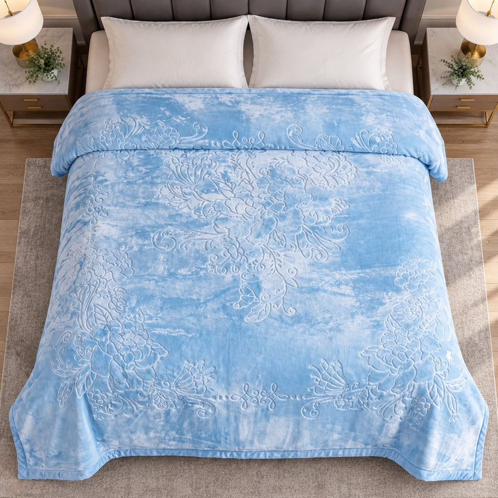 Blue embossed floral king blanket on bed