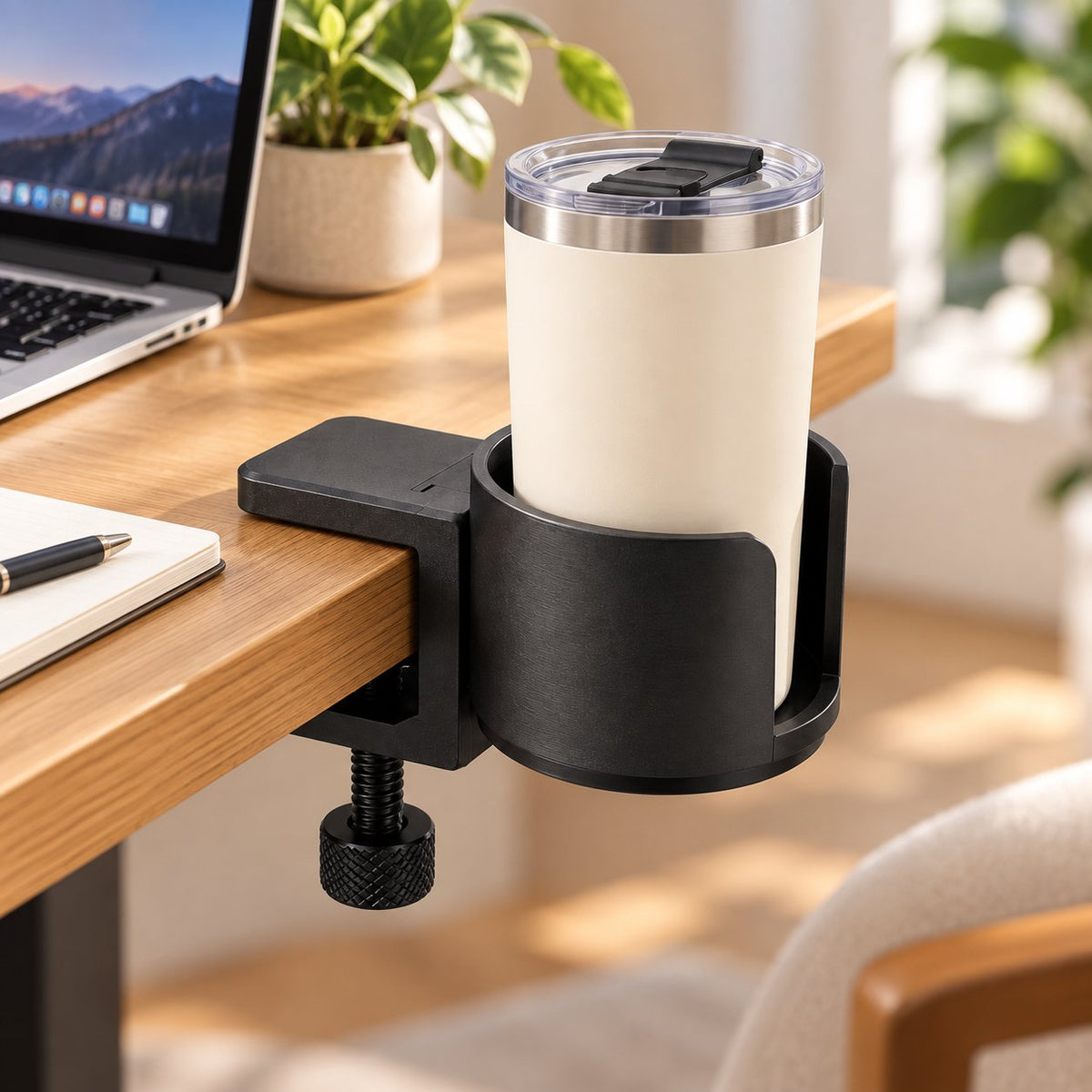 Black desk cup holder on office desk holding tumbler