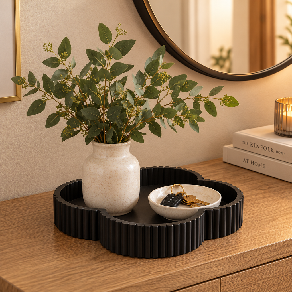 Black clover tray on entryway console with vase and keys