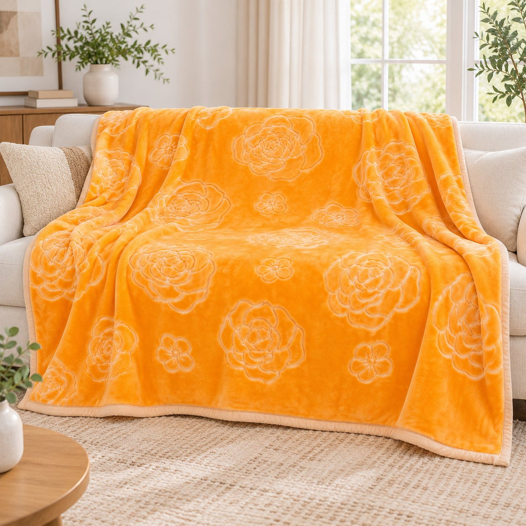 Gold embossed floral blanket on bed, beige bedroom