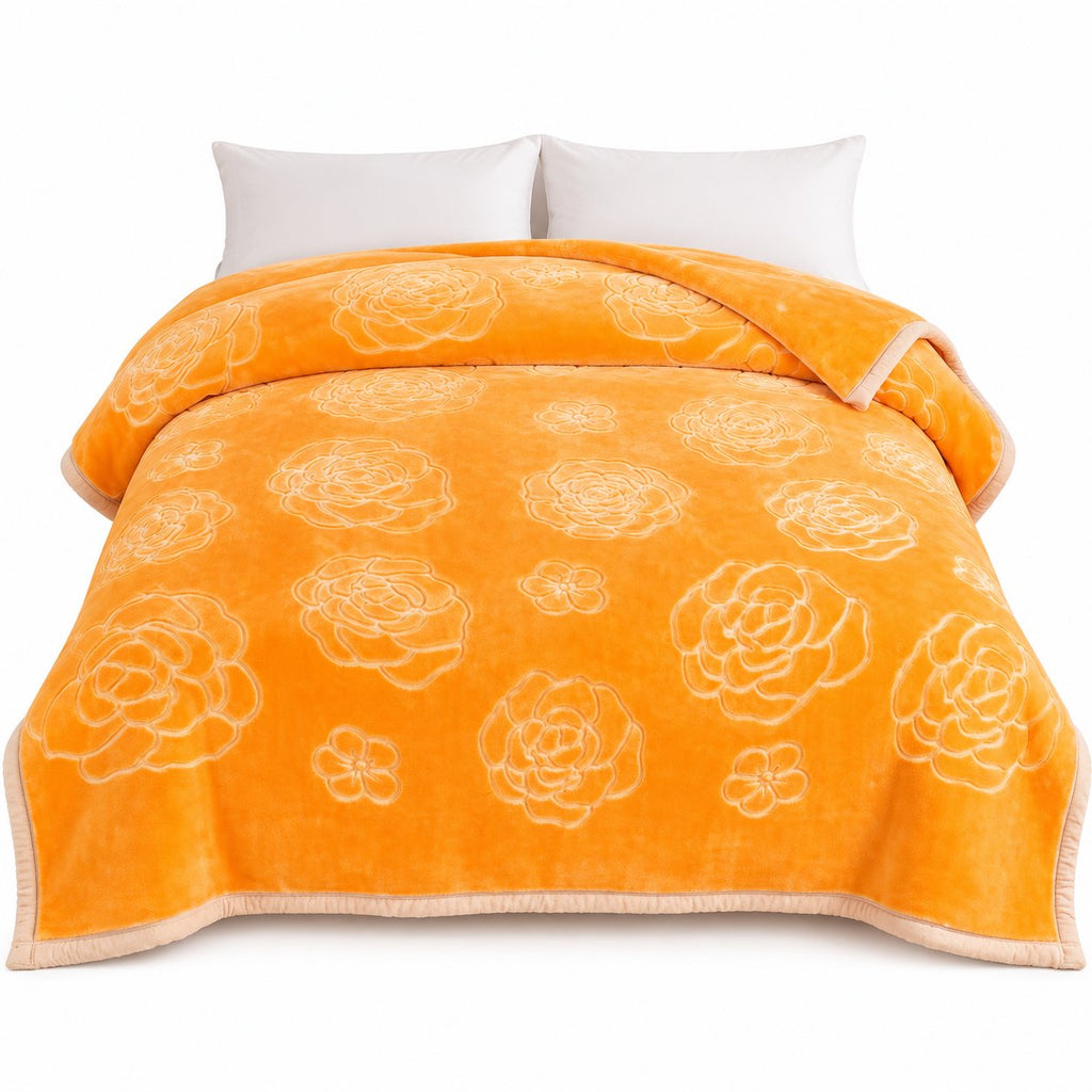 Gold embossed floral blanket on bed, side view
