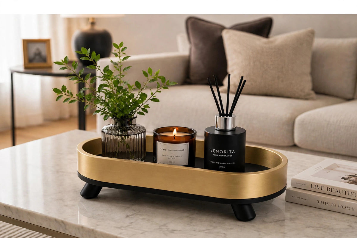 Gold oval tray on marble coffee table with decor books