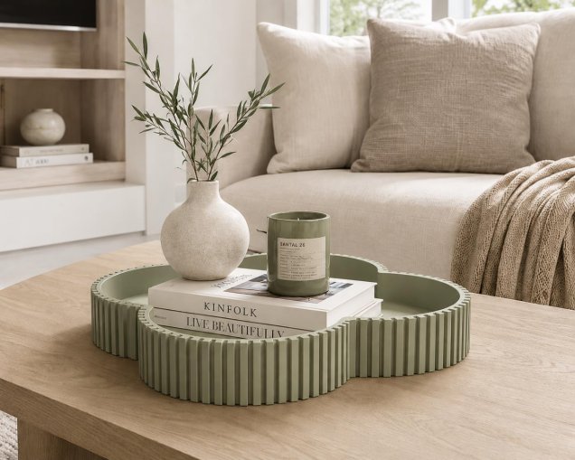 Green clover tray on coffee table with books and vase