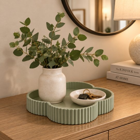 Green clover tray on entryway console with vase and keys