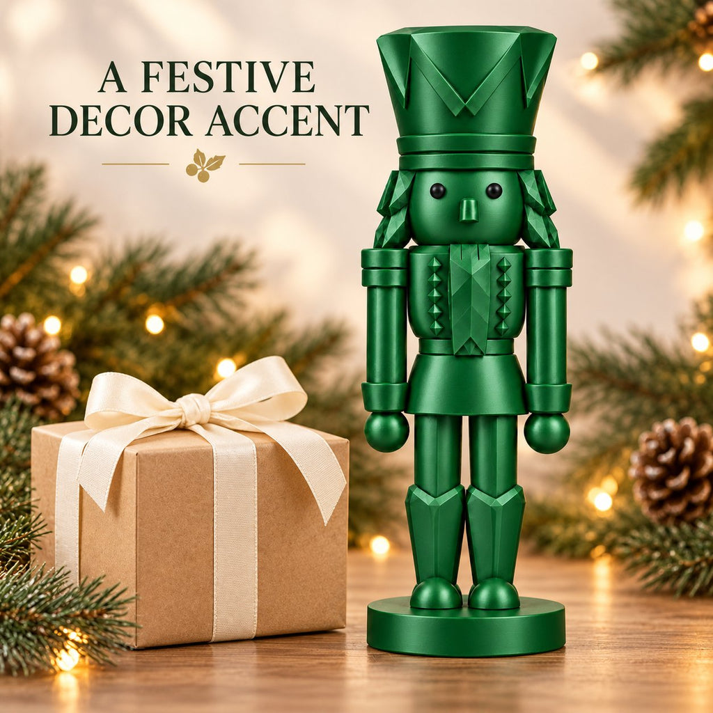 Emerald green nutcracker figurine beside a wrapped gift box