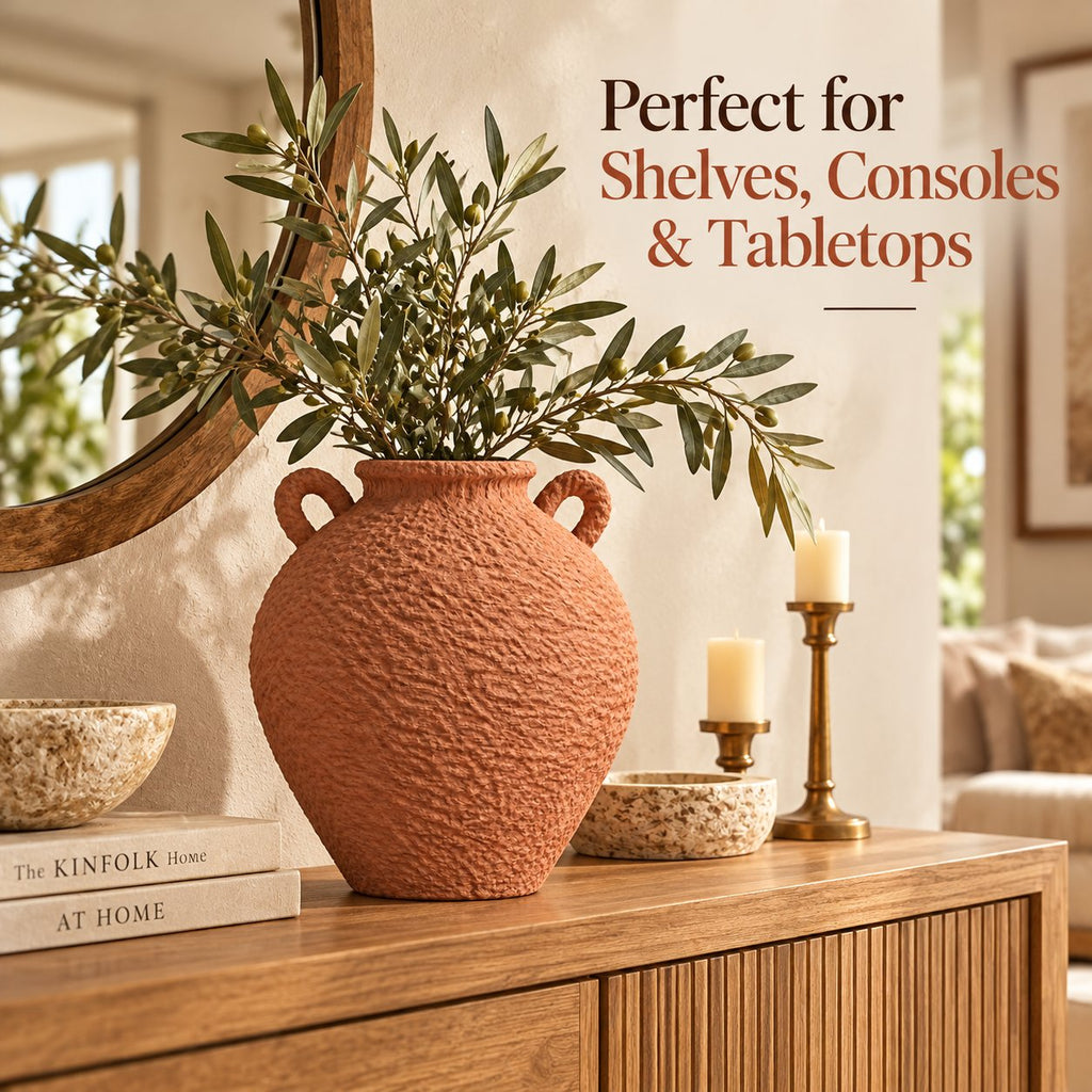 Terracotta textured vase styled on console with olive branches
