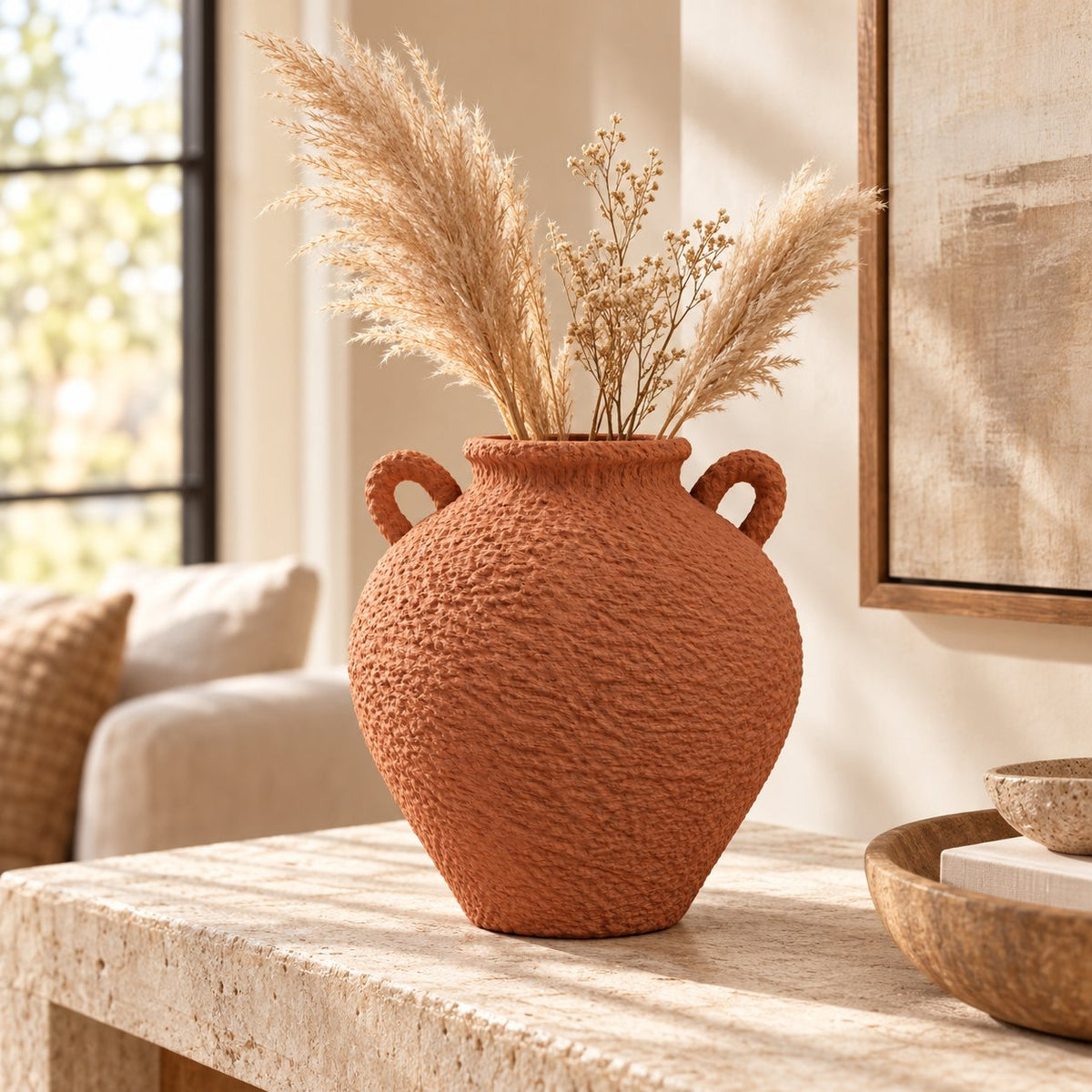 Terracotta vase with pampas grass on coffee table