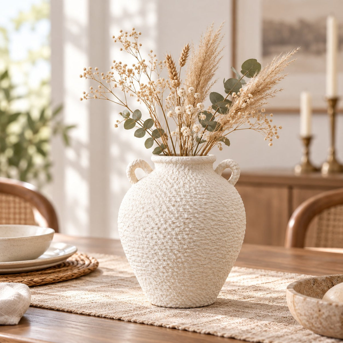 White textured vase on dining table with dried stems