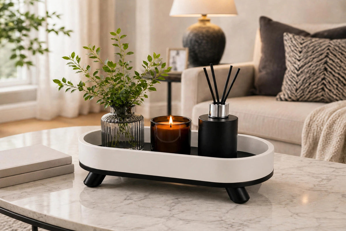 White oval tray on coffee table with vase, candle and diffuser