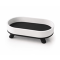 White and black oval decorative tray with feet, front view